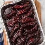 smoked party ribs in a rectangular aluminum foil pan.