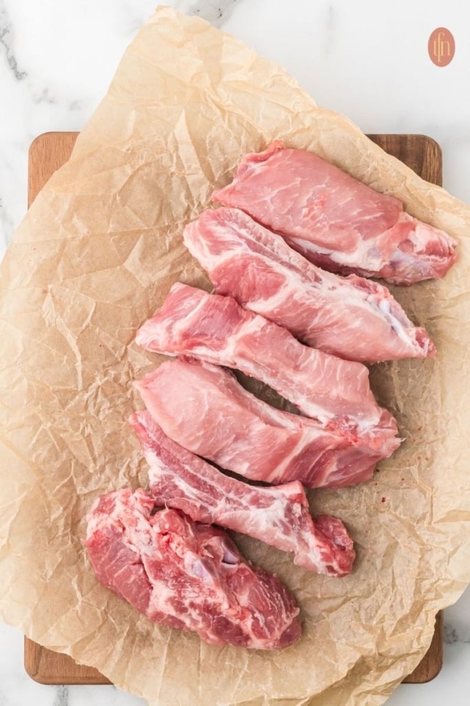 a raw pork ribs on a sheet of parchment paper.