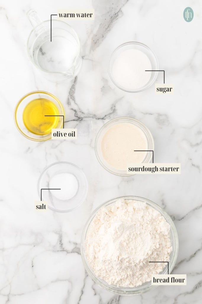 soft sourdough sandwich bread Ingredient Image: warm water, sugar, olive oil, sourdough starter, salt and bread flour.
