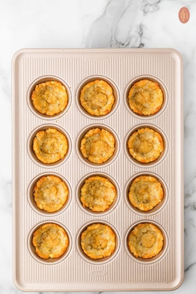 loaded tater tot cup prep on a muffin tin.