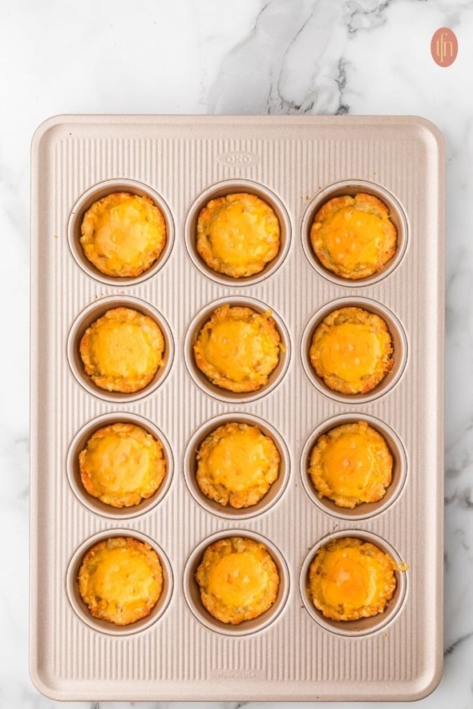 loaded tater tot cup prep on a muffin tin.