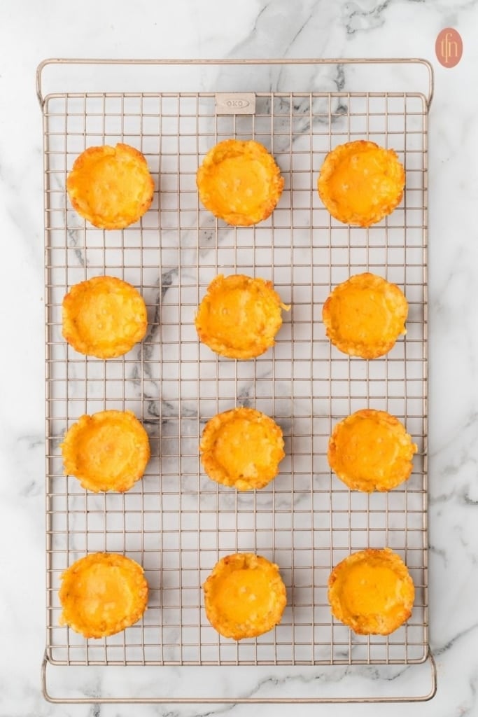 loaded tater tot cup prep on a wire cooling rack.