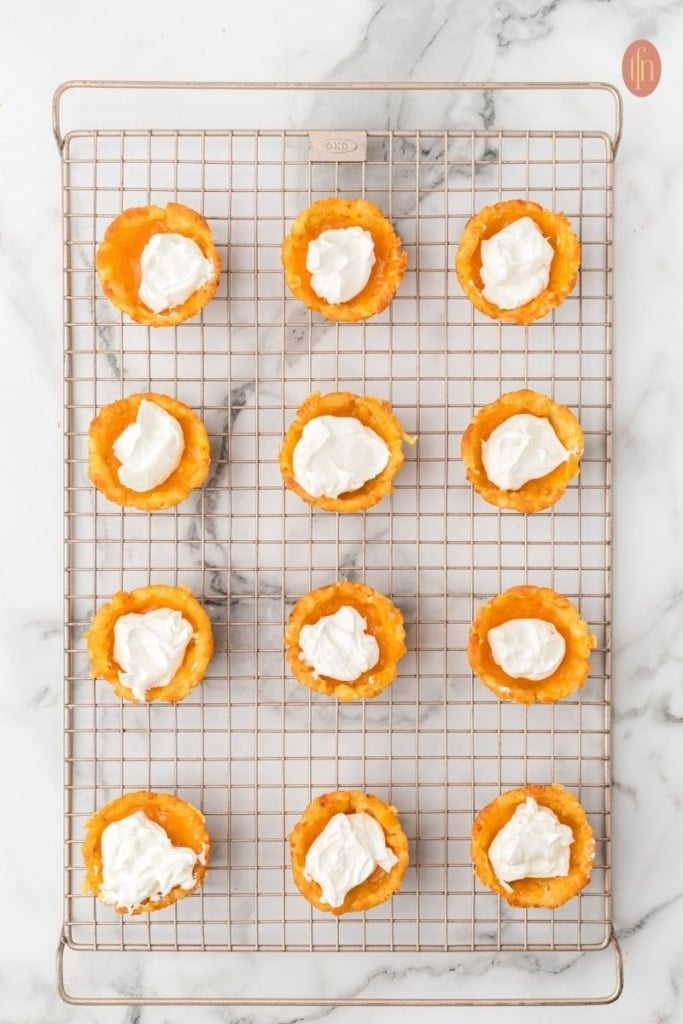 loaded tater tot cup prep on a wire cooling rack.