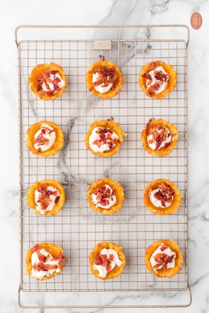 loaded tater tot cup prep on a wire cooling rack.