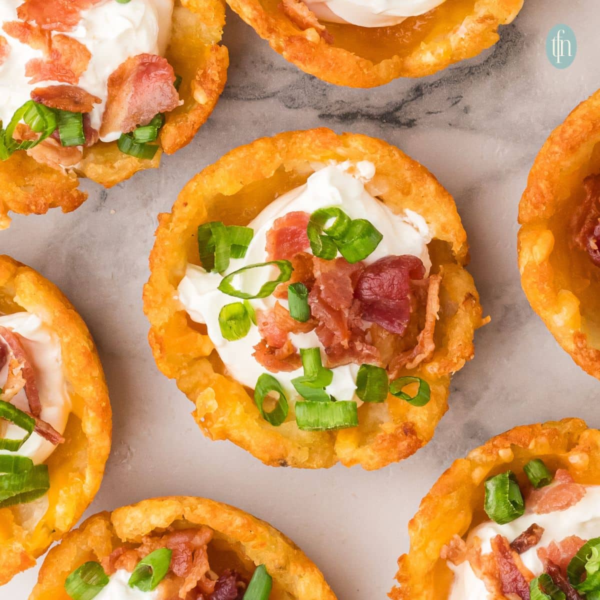 square image of loaded tater tot cups.
