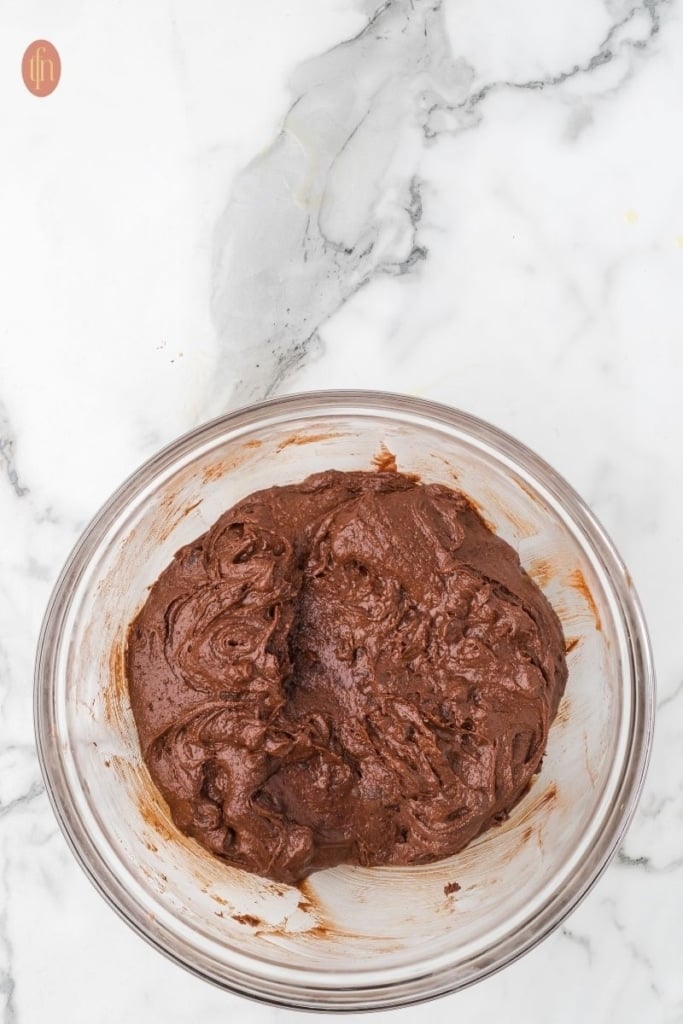 chocolate chip brownie batter in a clear glass bowl.