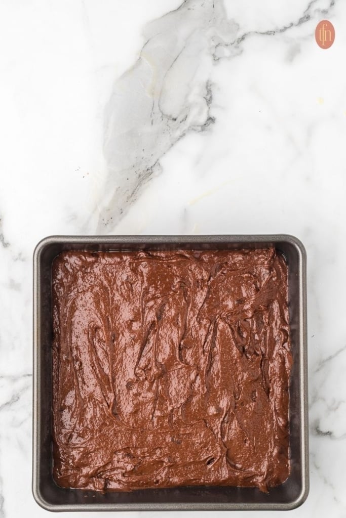 unbaked chocolate chip brownie on a baking pan.