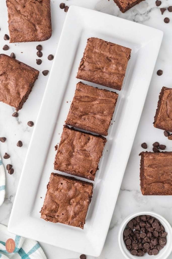 chocolate chip brownies on a rectangular plate.