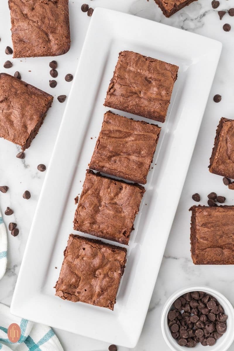 chocolate chip brownies on a rectangular plate.