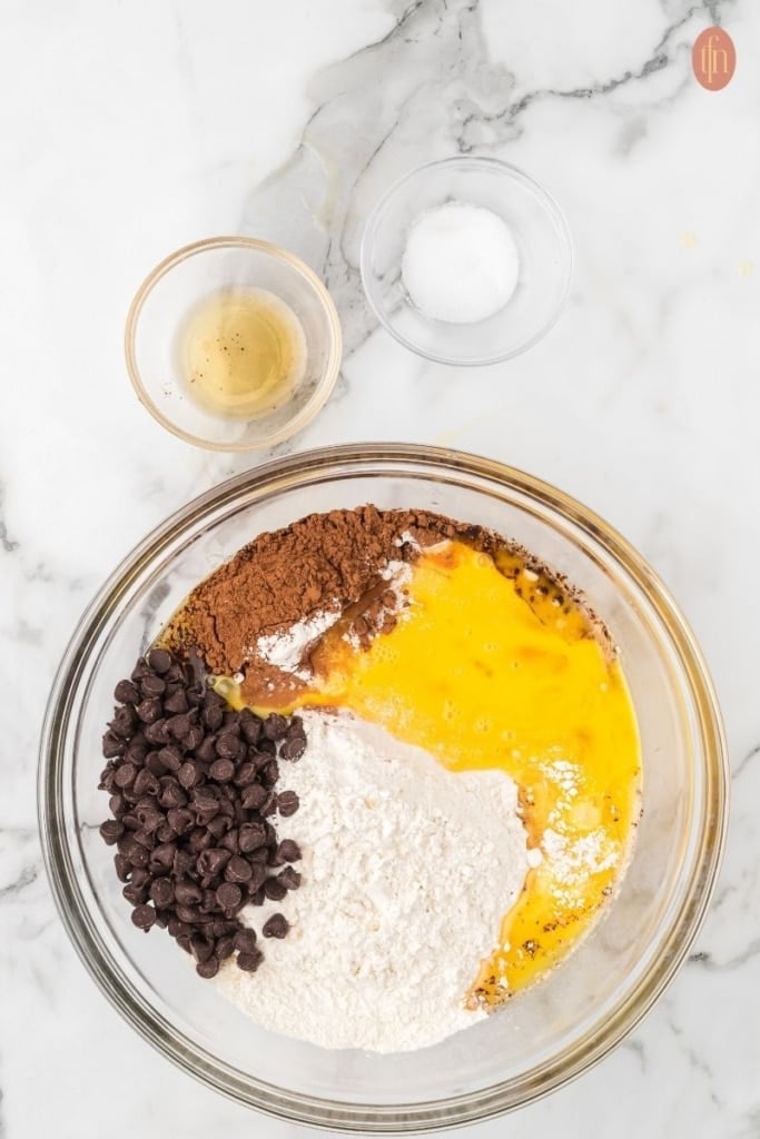homemade brownie ingredients in a clear glass bowl.