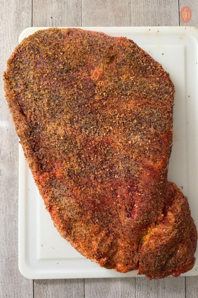 raw beef brisket coated with spices.