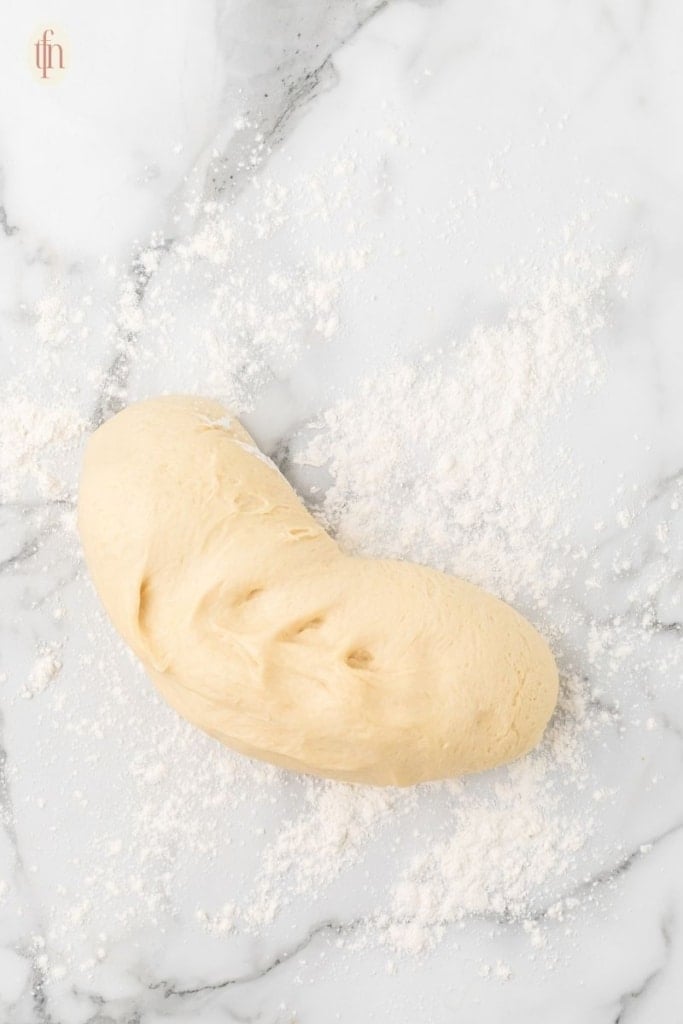 kneading Texas Roadhouse roll dough.