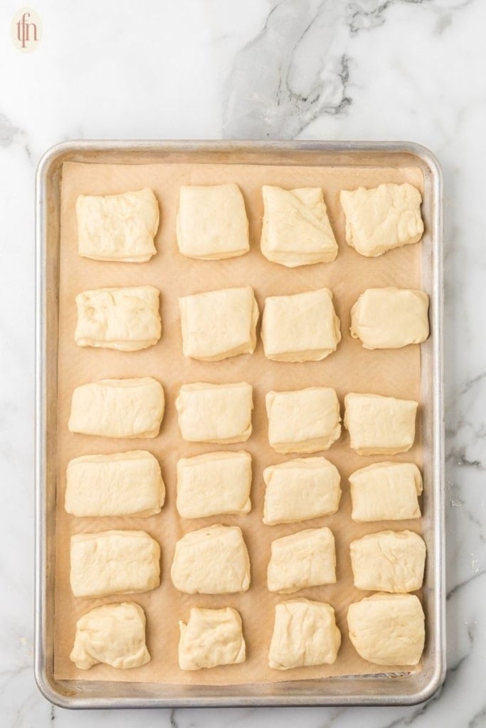 unbaked Texas Roadhouse Rolls on sheet.