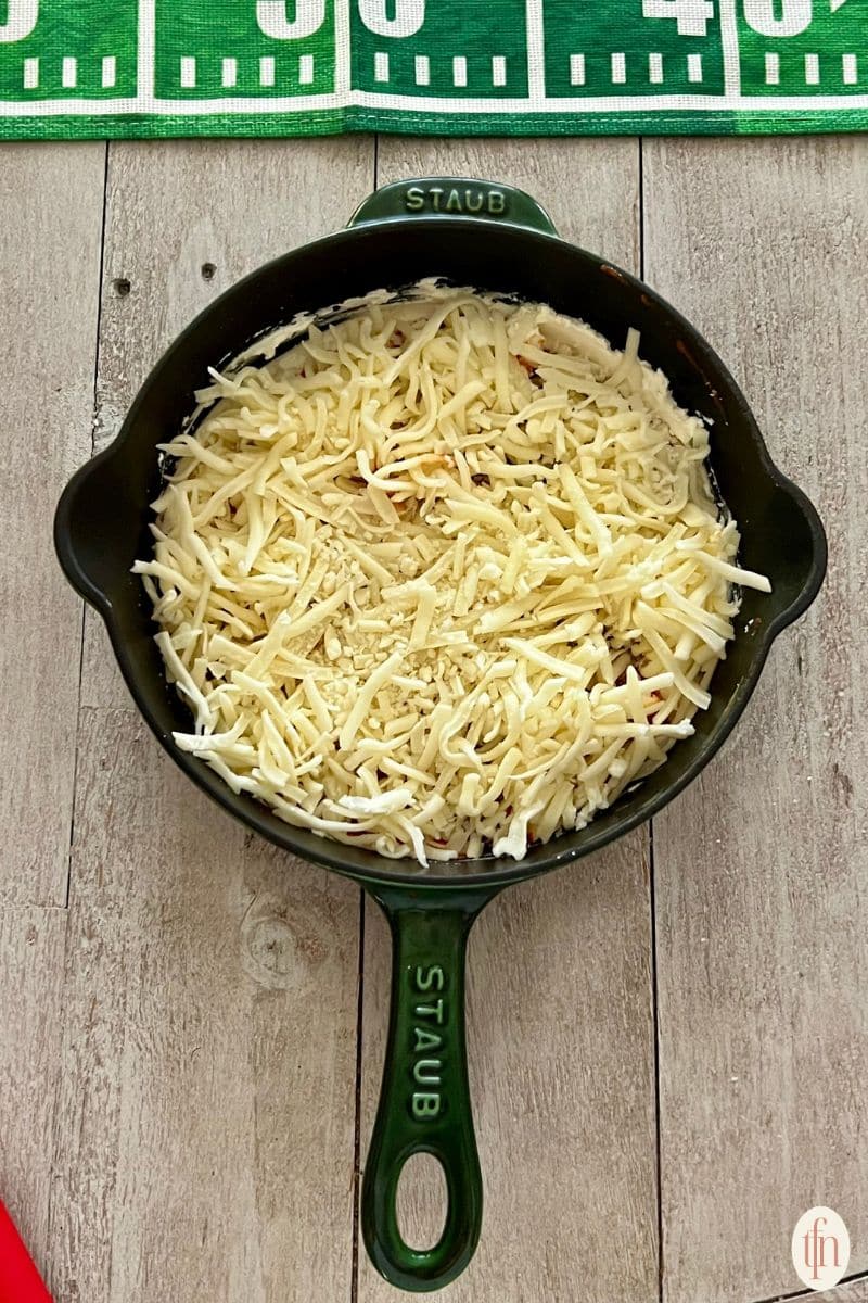 shredded cheese in skillet.