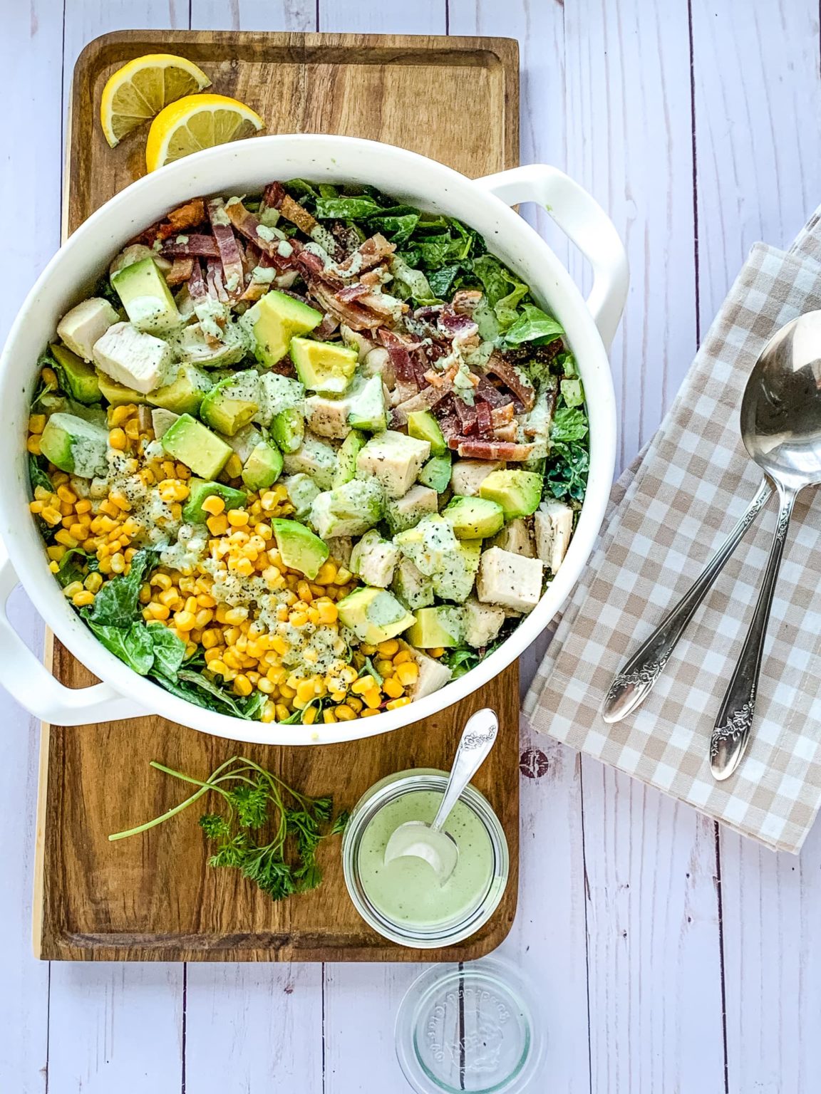 Panera Green Goddess salad in white bowl on a cutting board.